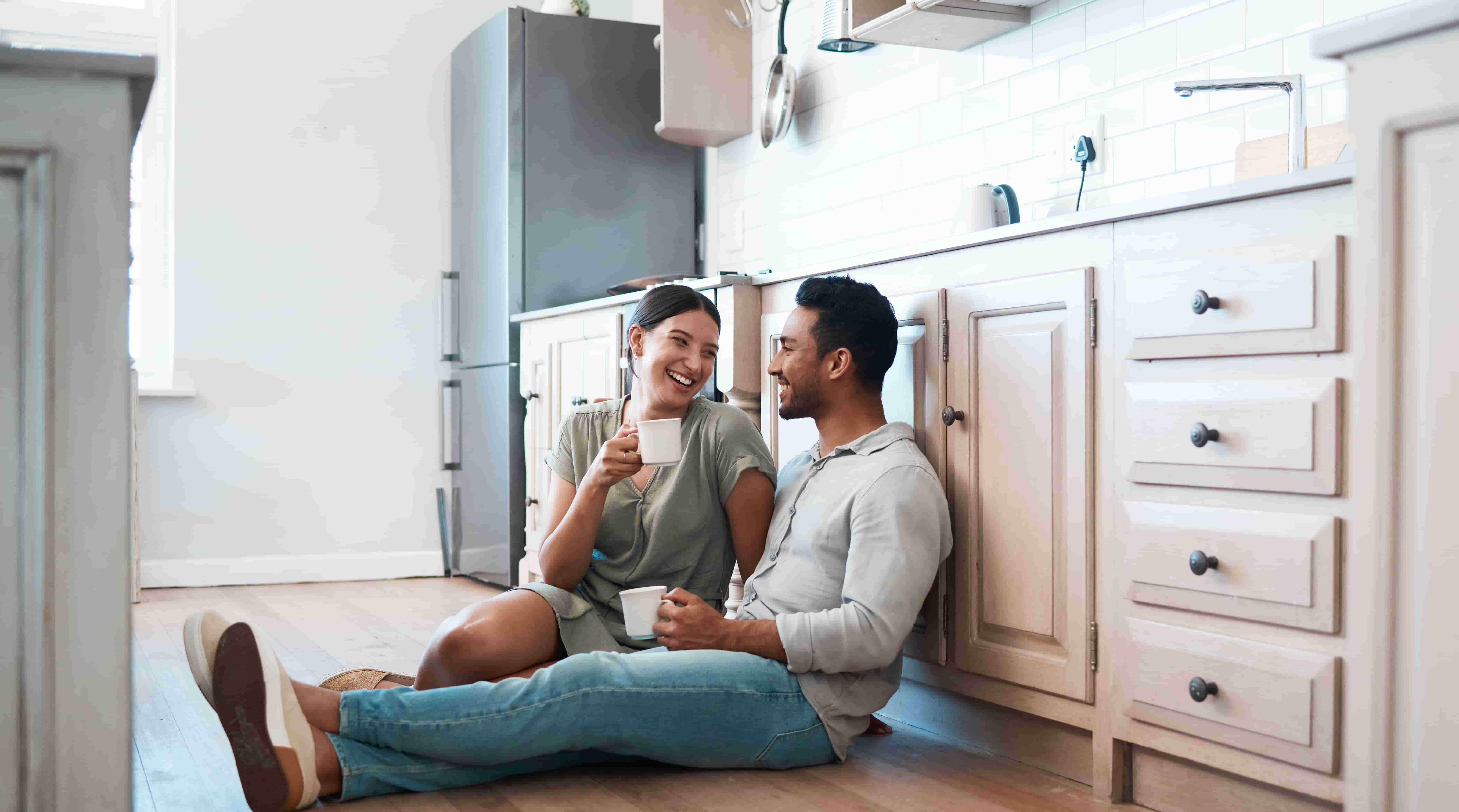 Shot of a young couple having a cup of coffee together at home