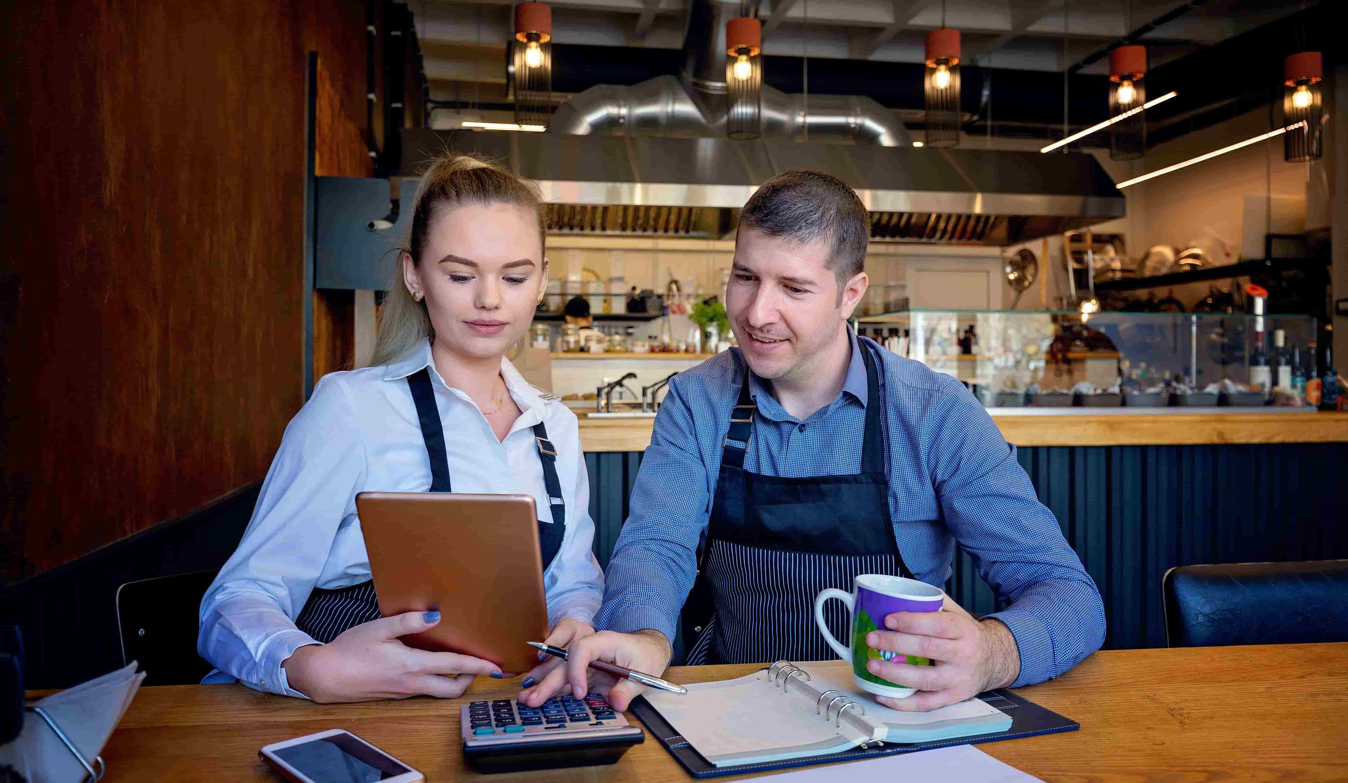 Small family restaurant owners checking monthly reports
